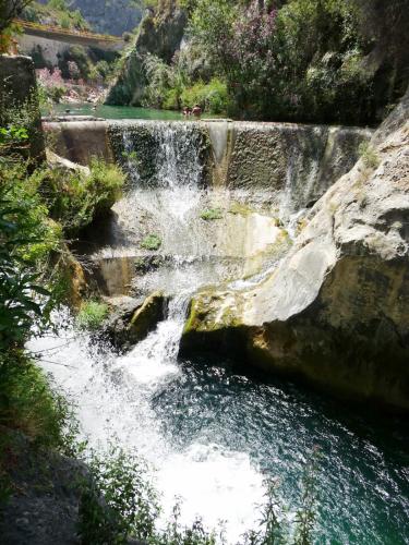 a waterfall on the side of a river at La Casona Albaida in Albaida