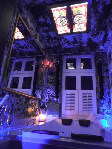 a house with a bath tub in a room with christmas lights at Mała Anglia Deluxe Rooms & SPA in Sopot