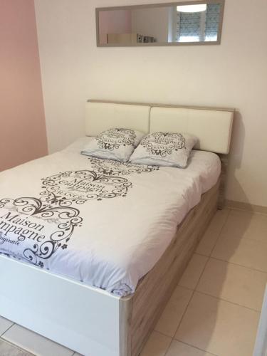 - un lit avec des draps et des oreillers blancs dans l'établissement Centre Historique de Colmar, à Colmar