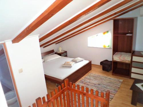 a small bedroom with a bed and a window at Turković Apartments in Žgaljić