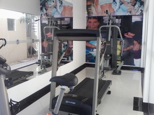 a gym with two tread machines and a treadmill at Catu Palace Hotel in Rondonópolis