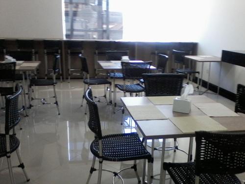 a dining room with chairs and tables and a room with tables and chairsktop at Catu Palace Hotel in Rondonópolis