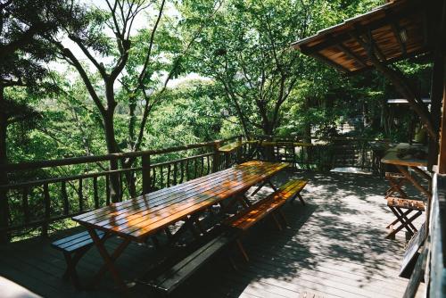 a wooden bench sitting on top of a deck at Villa Yumigahama in Minamiizu