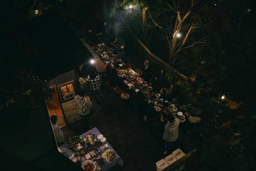 an overhead view of a group of people at a restaurant at night at Villa Yumigahama in Minamiizu