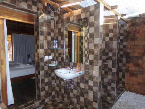 a bathroom with a sink and a mirror at Green Bowl Beach Villas in Uluwatu