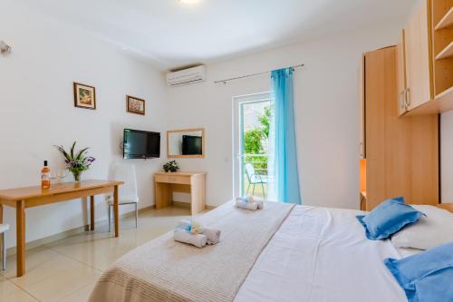 a bedroom with a bed with two stuffed animals on it at Holiday house Barbara in Supetar