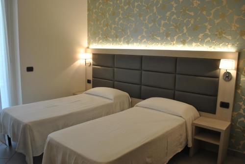 Ένα ή περισσότερα κρεβάτια σε δωμάτιο στο Hotel Residence Laigueglia free parking