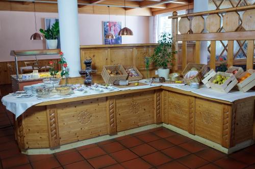 a kitchen with wooden cabinets and a white counter top at Pension Pirkdorfer See in Sankt Michael ob Bleiburg