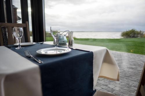 a table with a blue table cloth and wine glasses at Žvejų užeiga in Šiauliai
