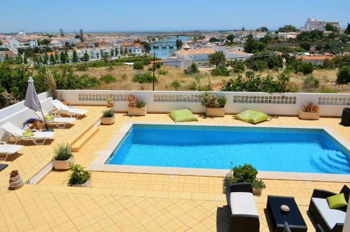 a swimming pool on top of a building at Tavira Terrace in Tavira