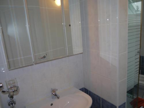 a bathroom with a sink and a mirror at Hévíz -Alsópáhok Villa-Erika Apartman in Alsópáhok