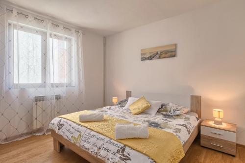 a bedroom with a bed with two pillows on it at Apartman D&D, Dvorine 63 in Banjole