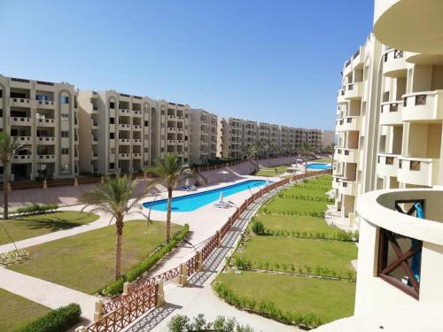 a view of the pool from the balcony of a apartment building at Mohamed Afifi Stella Heights - Sidi Abdel Rahman - Families - 3 Bed rooms in El Alamein