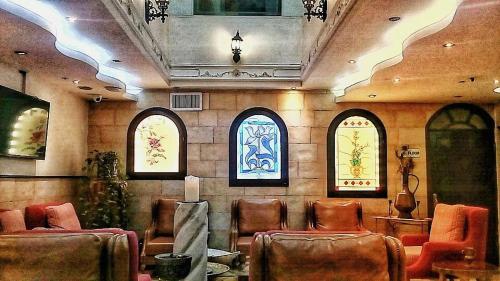 a waiting room with chairs and stained glass windows at Hashimi Hotel in Jerusalem
