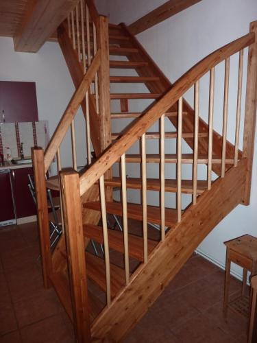 a wooden staircase in a house with wooden rails at Rodinny penzion Kunc in Slavonice