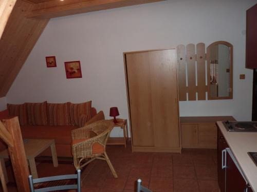 a living room with a couch and a table at Rodinny penzion Kunc in Slavonice
