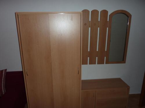 a wooden cabinet with a mirror in a room at Rodinny penzion Kunc in Slavonice