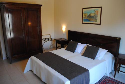 a bedroom with a large bed and a cabinet at Hotel Park Siracusa Sicily in Syracuse