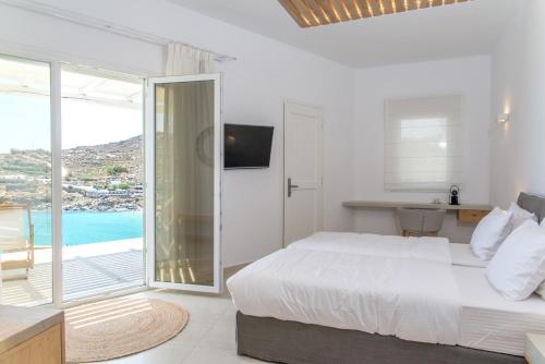 a bedroom with a bed and a view of the ocean at Super Paradise Hotel in Super Paradise Beach