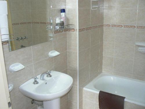 y baño con lavabo, aseo y ducha. en Departamentos Santa Monica en Puerto Madryn