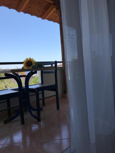 a dining room with a table and chairs on a balcony at Joy Hotel in Sarandë