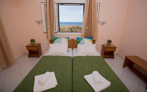 a bedroom with a large bed with a window at Agnanti in Xi