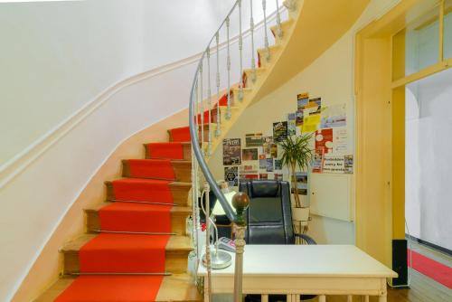 a staircase with red carpeting in a office building at Suntrap Hostel in Lagos