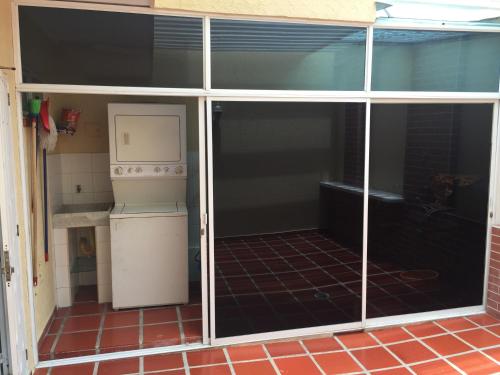 a sliding glass door of a kitchen with a stove at Stone Creek Barranquilla in Barranquilla