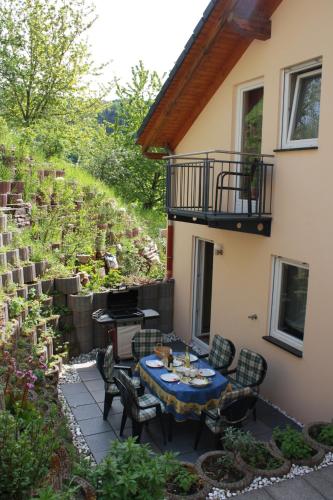 a patio with a table and chairs next to a building at Ferienhaus Trimmisch in Ediger-Eller