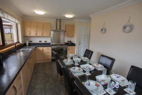 a kitchen with a table with dishes on it at GOLFVIEW 4 in Buckie