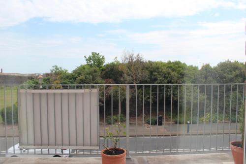 a fence in front of a parking lot at By The Sea Bed and Breakfast in Eastbourne