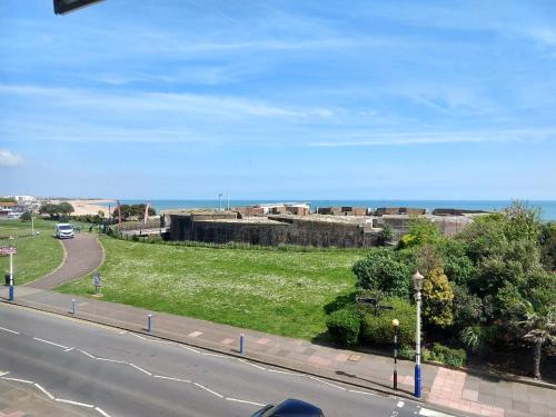 a view of a street with the ocean in the background at By The Sea Bed and Breakfast in Eastbourne