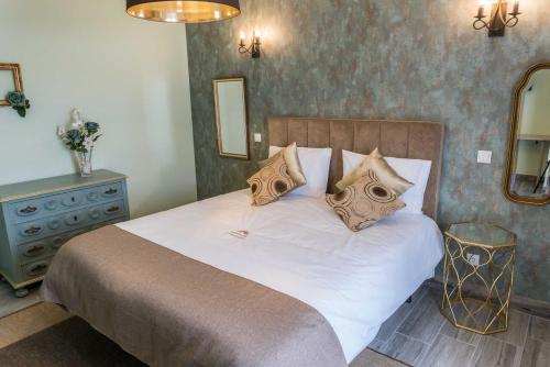 a bedroom with a large bed with white sheets and pillows at Quinta Sao Martinho in Reguengo Grande