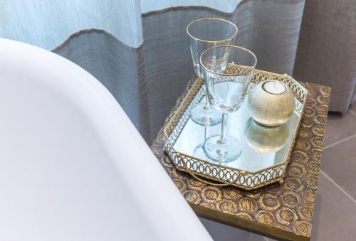 a tray with two wine glasses on a table at Riva Palace in Split