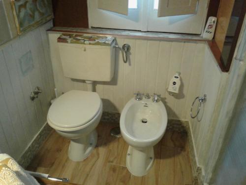 a small bathroom with a toilet and a sink at La Casetta Di Anna in Castel Lagopesole