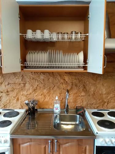 a kitchen with a sink and a counter with dishes at Hostel31 in Tallinn