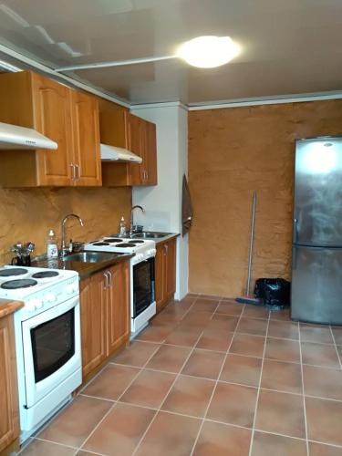 a kitchen with white appliances and wooden cabinets at Hostel31 in Tallinn