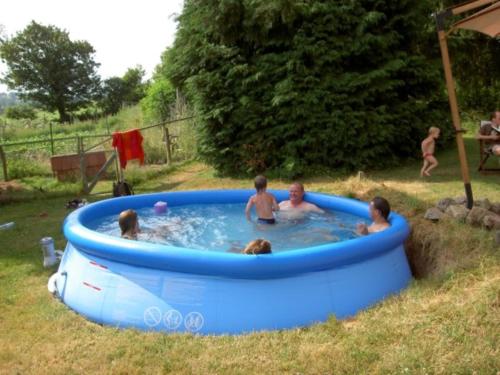 een groep mensen in een bubbelbad in een tuin bij Sans Parure : Chambre d'hôte in Buxières-sous-Montaigut