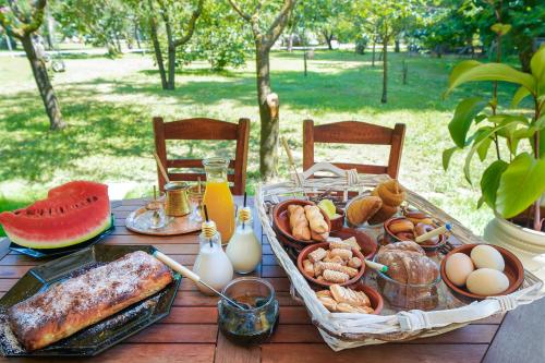 a picnic table with a tray of breakfast foods at Natura Bungalows-Villa in Limenas