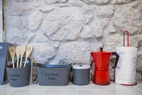 a group of containers and utensils on a counter at Apartments Stinice in Gradac