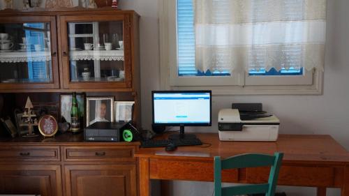 a desk with a computer sitting on top of it at Hotel Hara in Naxos Chora