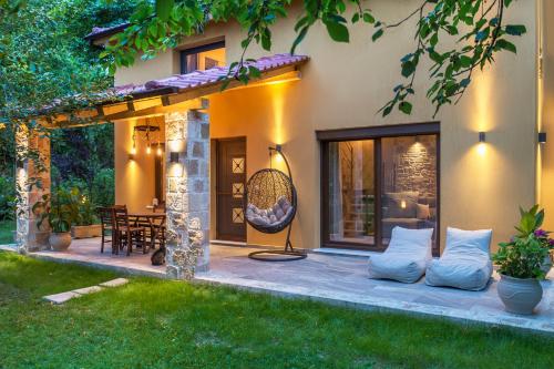 a patio of a house with pillows on it at Natura Bungalows-Villa in Limenas