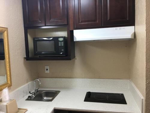 a kitchen with a sink and a microwave at Chaparral Motel in Port Lavaca