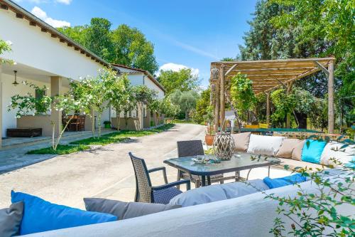 an outdoor patio with a table and chairs at Natura Bungalows-Villa in Limenas
