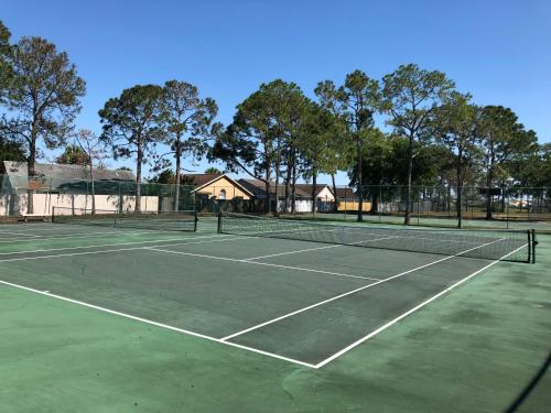 a tennis court with a tennis racket on it at Laguna Villas in Kissimmee