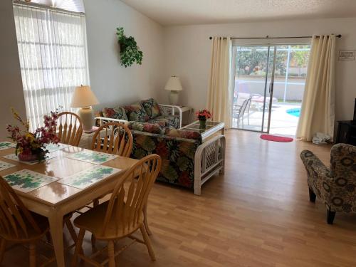 a living room with a table and a couch at Laguna Villas in Kissimmee