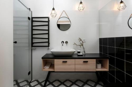 a bathroom with a sink and a mirror at Aloza in Ustka