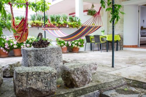 a hammock in a courtyard with potted plants at Apartments Stinice in Gradac