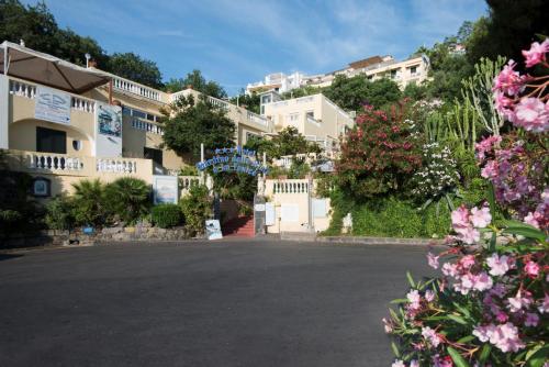 a street in front of a building with flowers at Hotel Giardino Delle Ninfe E La Fenice in Ischia