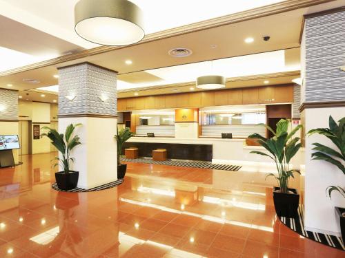 a lobby with potted plants in a building at APA Hotel Sapporo Susukino Ekinishi in Sapporo